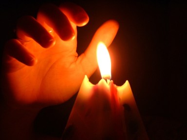 hand-over-candle-1495809