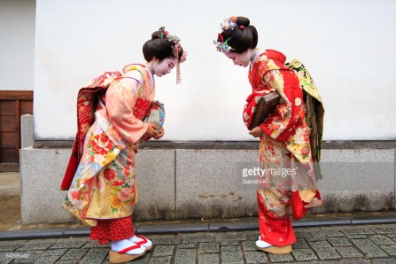 Japanese Maiko girls bowing each other